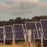 A row of solar panels in a field
