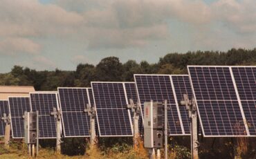 A row of solar panels in a field